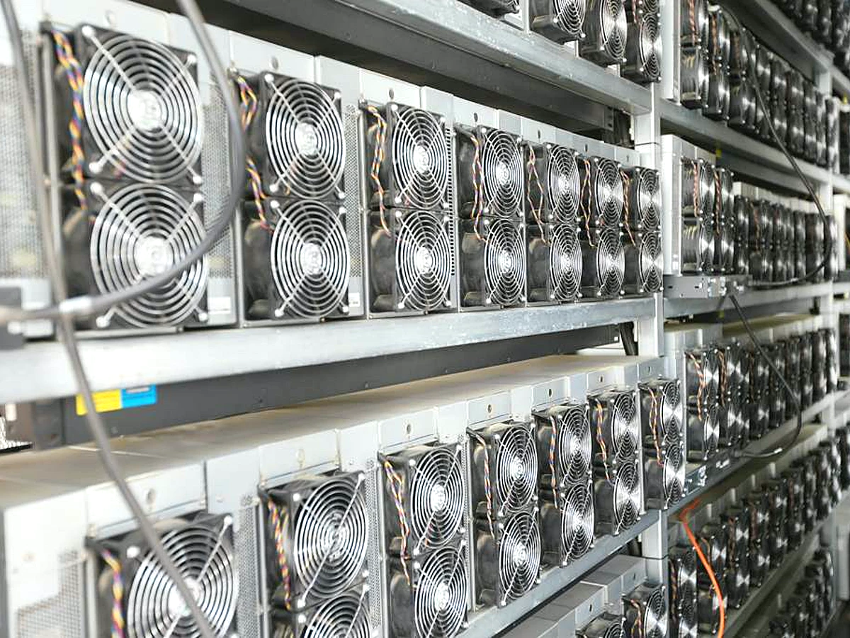Rows of ASIC mining machines with visible cooling fans reference image for AC5