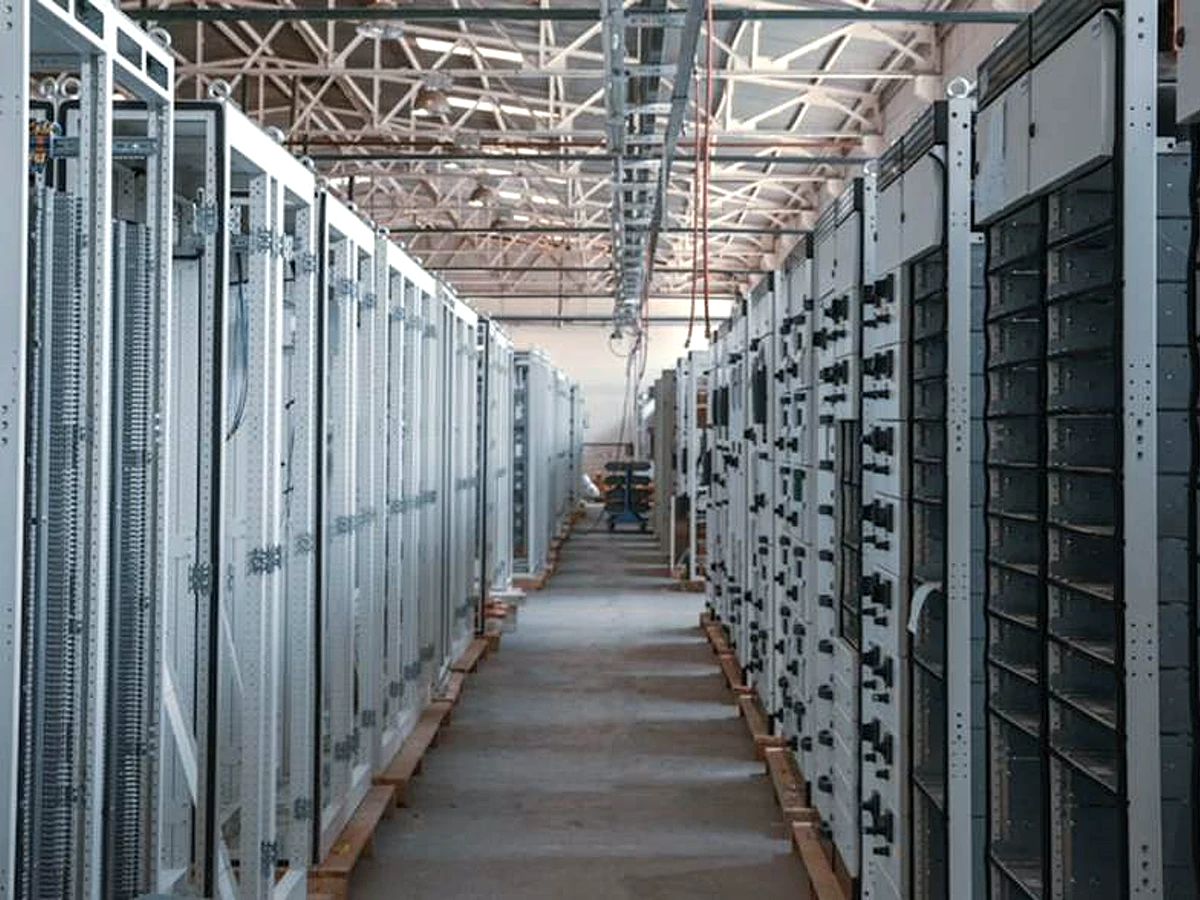Bright equipment cabinet aisle reference image for AC7