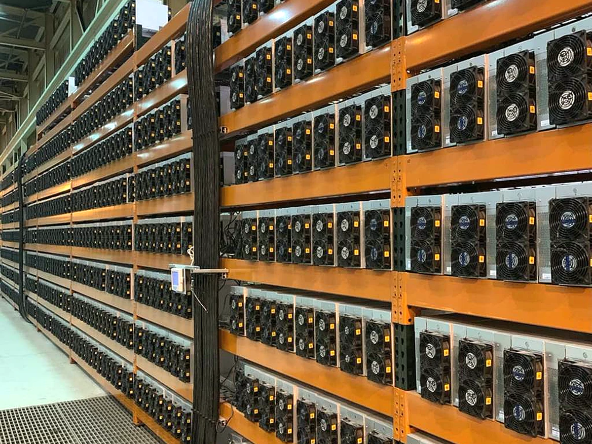 Industrial ASIC mining facility with dense machine racks reference image for AC11